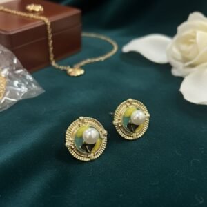Round shaped pearl earrings - green and yellow enamel