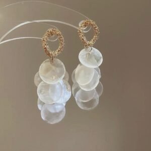 Gold toned dangle earrings with white circular shell